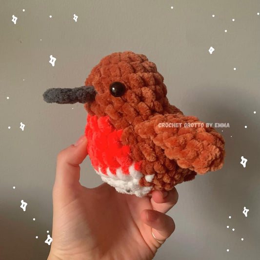 A crochet rufous hummingbird plushie showing the left side.