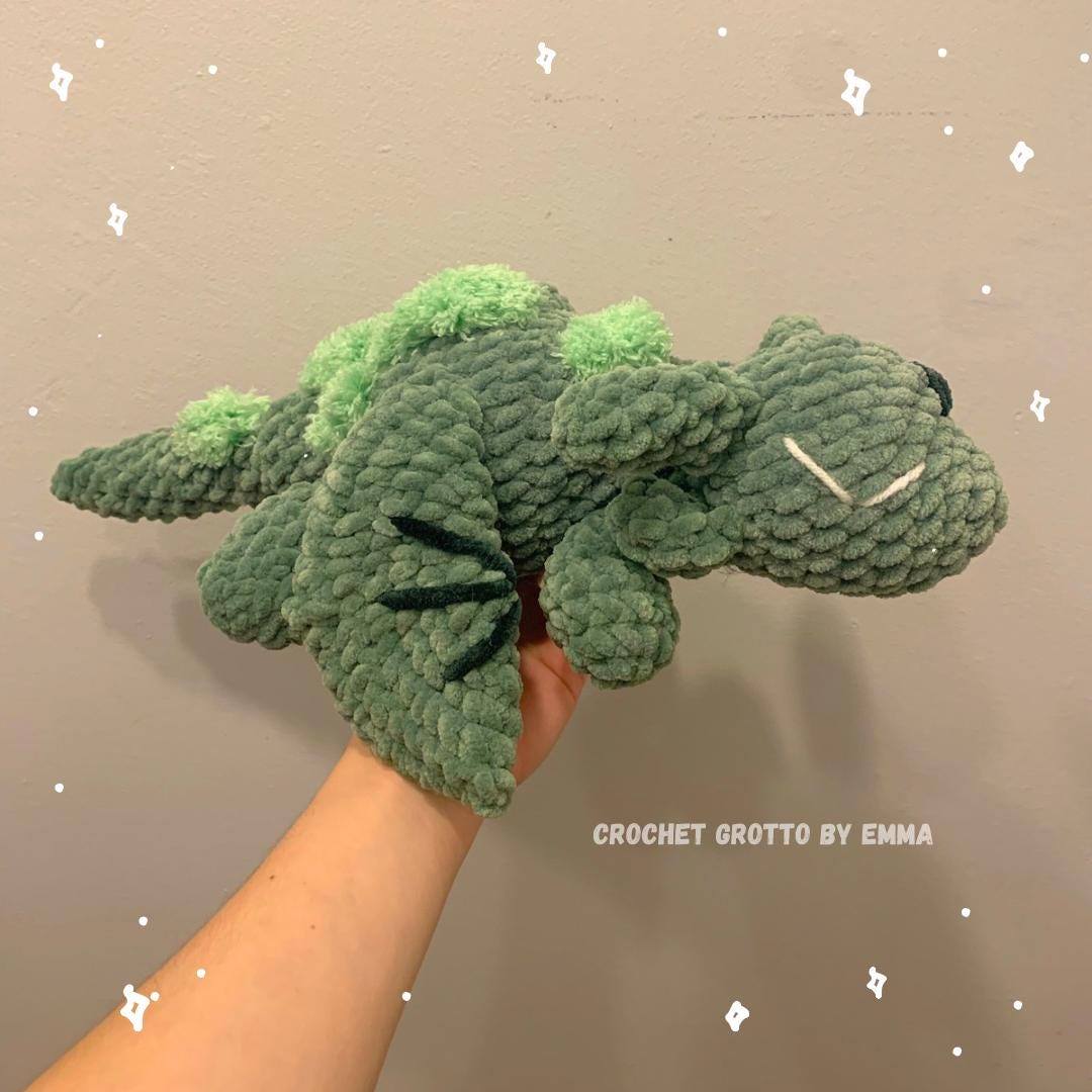 A cute green dragon with green moss patches sprouting on its back.