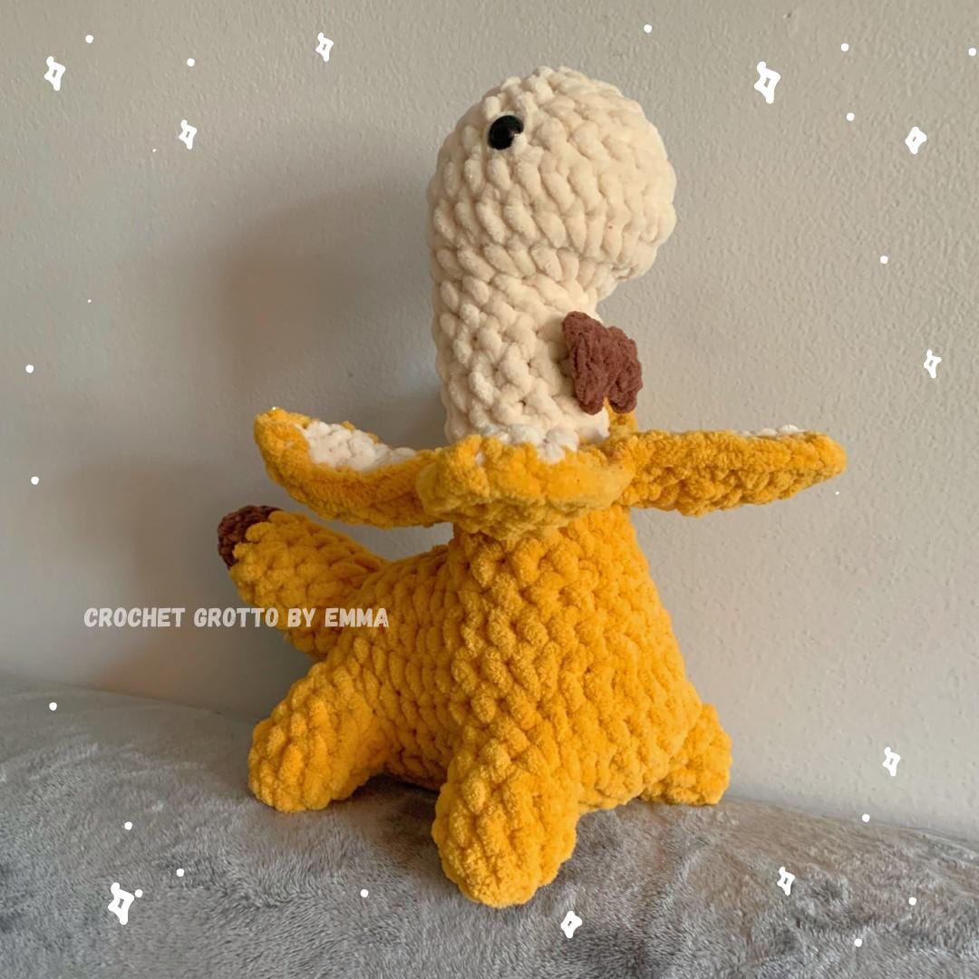 A banana dinosaur crochet plushie with a bow tie!