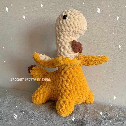 A banana dinosaur crochet plushie with a bow tie!